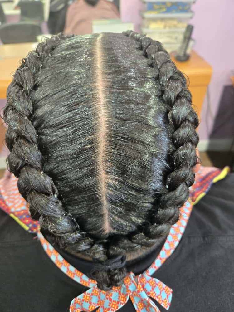 Two-cornrow style by Akwaba Hair Braiding